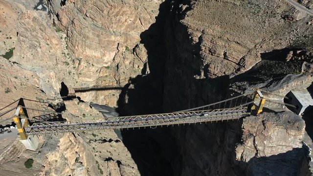 Aerial shot of a car driving on asia's highest bridge , chicham khaas , spiti valley  | Going up