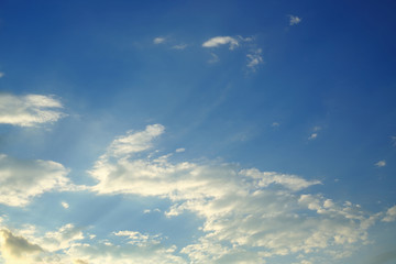 sunlight shine through cloud on dramatic blue sky background
