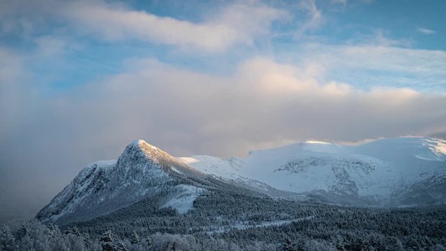 Snowy mountin view while the sun is about to set.
