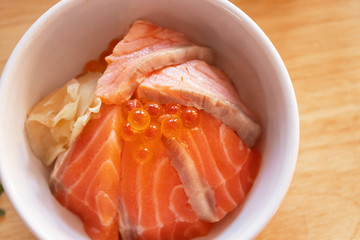 Japanese food salmon ikura don salmon and ikura with rice. Top view on wooden table.