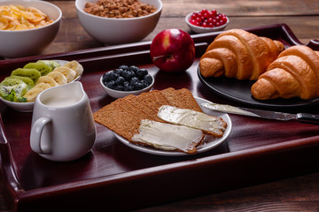 Delicious breakfast with fresh croissants and ripe berries