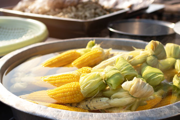 Sweet corn boiling in the pot at street food market. 