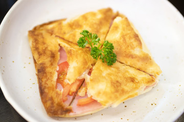 Puff pastry pies with ham and tomato. 