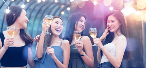 group of beautiful attractive asian friend female celebrating rooftop party together with cheerful drink dance mith rhythm party music with light flare and bokeh background