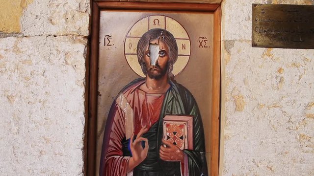 Devastated fresco of Jesus Christ in  church in Syria