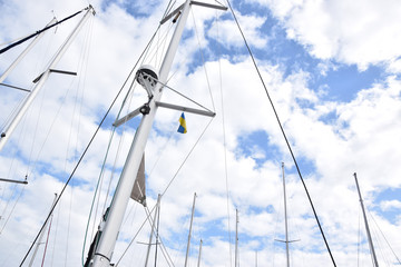 Fototapeta premium Sailing yachts masts in the sky in marina harbour