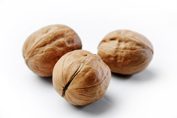 Three walnuts on a white background.
