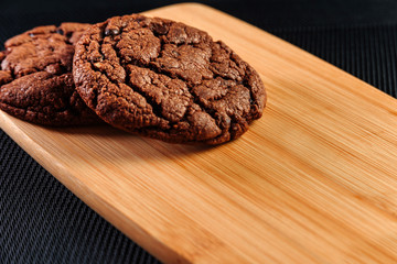 Chocolate chip cookies on a wooden tray.
