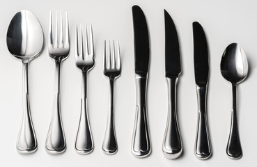 Set of silver cutlery on a white background