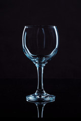 Wine glass on black background, front view
