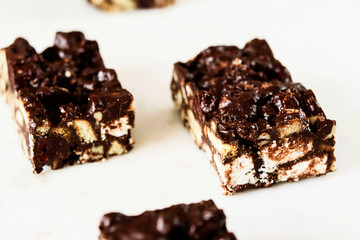 Raw Chocolate Hazelnut cake slices on white marble background. Selective focus