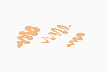 Liquid foundation swatch isolated on white background. Close Up of makeup cream sample.