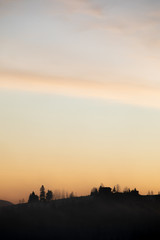 Fototapeta na wymiar silhouette of village in mountains on sunrise