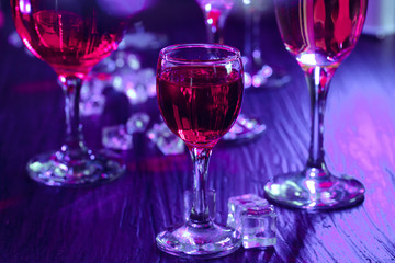 Cocktail drinks with ice in club lights