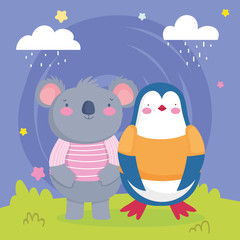 Naklejka premium cute koala and penguin in the grass