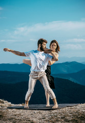 Beautiful couple dancing hip-hop in nature