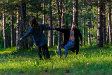Naklejka na ściany i meble Carefree man in the woods practicing with an attractive colleague