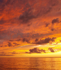 Fototapeta na wymiar Orange coloured stratocumulus cloudy coastal Sunset Seascape. Australia