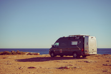 Fototapeta na wymiar Camper van on sea cliff, camping.