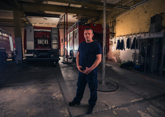 Portrait of fireman standing inside the fire department