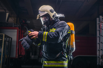 Naklejka premium Firefighter with protective uniform wearing oxygen mask