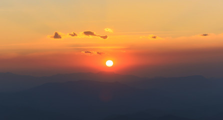 Fototapeta na wymiar the sun sets behind the mountain peaks, captured at chiangmai, thailand