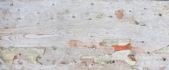 Old cracked plywood with a beautiful texture. Frame with an unusual background and free space for ad, advertisement, advertising.