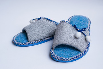 Slippers with pompons isolated on a white background. Home women's or children's clothing. The concept of home warmth and comfort. Selective focus.