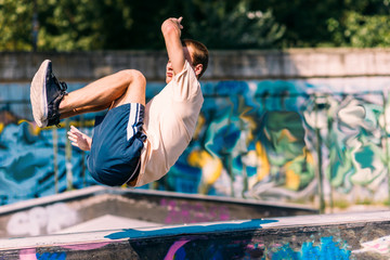 Young man doing tricks while jump in the air