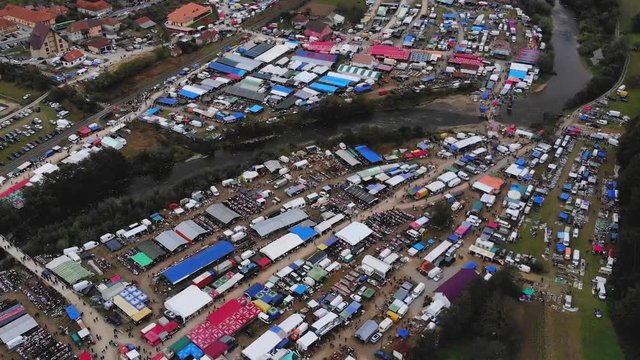 Bird's eye view of the largest Romanian flea market from Negreni with both sides of river Cris visible