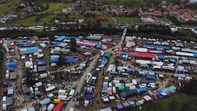 Bird's eye view of the largest Romanian flea market from Negreni, with train leaving in the background