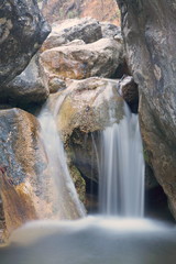 Fototapeta na wymiar Little waterfall in rocks