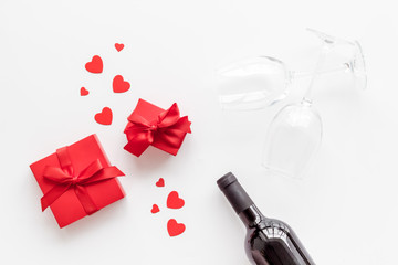 Valentines Day concept with wine and red present box on white background top-down