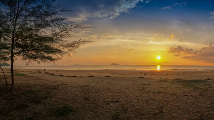 view seaside panorama on sand beach with yellow sun light and cloudy sky background, sunset at Laem Son Beach, Laem Son National Park, Ranong, southern of Thailand.