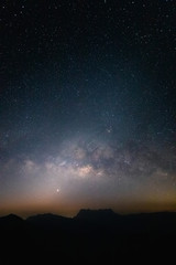 Milky way with night landscape silhouettes mountain