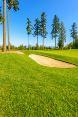 Golf course with gorgeous green and sand bunker