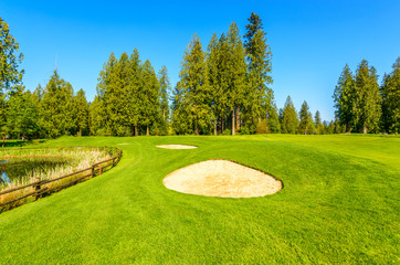 Golf course with gorgeous green and sand bunker