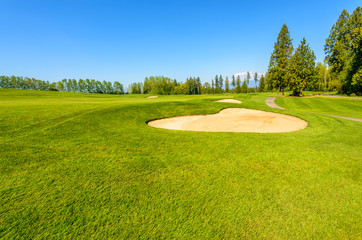 Golf course with gorgeous green and sand bunker
