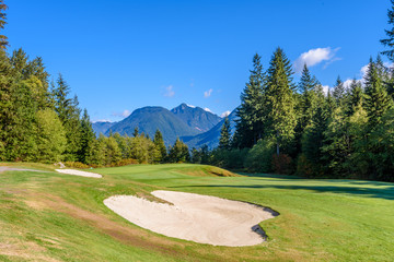 Golf course with gorgeous green and sand bunker