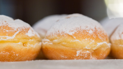 Side view (close up) of austrian Krapfen. In northern parts of Germany called Berliner. A doughnut, especially popular during carnival. Sweet with sugar on top.