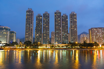 Fototapeta na wymiar High rise residential building and river in Hong Kong city at dusk