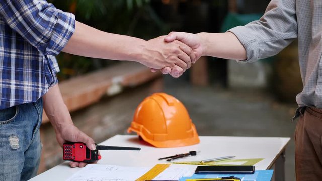 Two engineer shaking hands with contractor after success project construction, handshake.