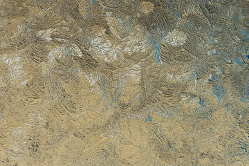 Pattern of magical fantastic plants. Abstract light yellow beige background or wallpaper. It looks like expressive strokes of oil paint. Drawing of ice on a window pane in winter. Low contrast