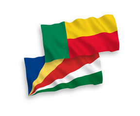 National vector fabric wave flags of Benin and Seychelles isolated on white background. 1 to 2 proportion.