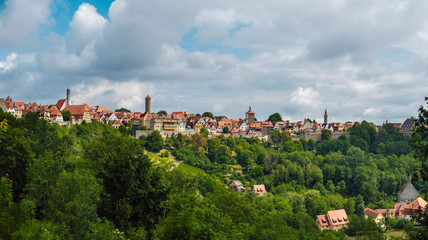 Beautiful picturesque panoramic view of Rothenburg ob der Tauber, its colorful houses and fortress walls. A preserved medieval German city and UNESCO site that attracts millions of tourists.