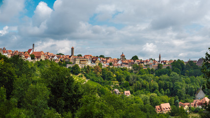 Fototapeta premium Beautiful picturesque panoramic view of Rothenburg ob der Tauber, its colorful houses and fortress walls. A preserved medieval German city and UNESCO site that attracts millions of tourists.