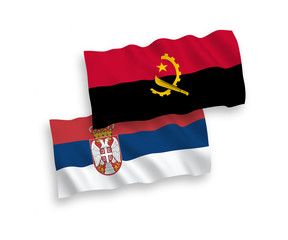 National vector fabric wave flags of Angola and Serbia isolated on white background. 1 to 2 proportion.