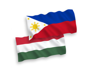National vector fabric wave flags of Philippines and Hungary isolated on white background. 1 to 2 proportion.
