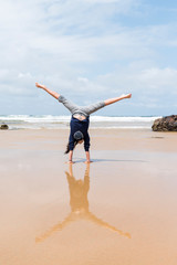 Child doing handstands at the beach at Phillip Island, Victoria Australia