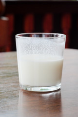 Close up glass of ayran. Traditional oriental turkic sour milk drink in the glass on the table. Kefir